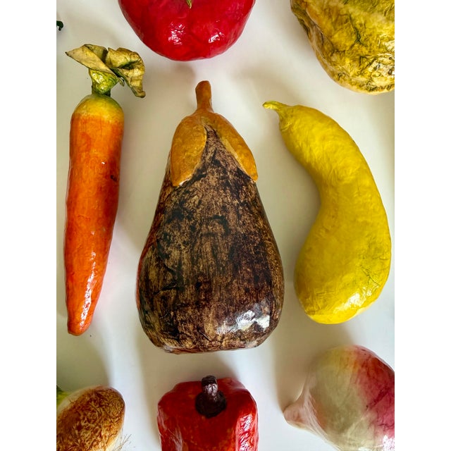 Here is a wonderfully unusual mid-20th century collection of 14 hand-painted papier-mâché vegetables. Individually formed...