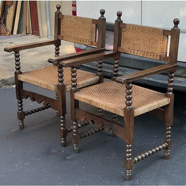 This is a wonderful pair of 19th century French Louis XVIII style carved walnut bobbin turned arm chairs with rush seats...