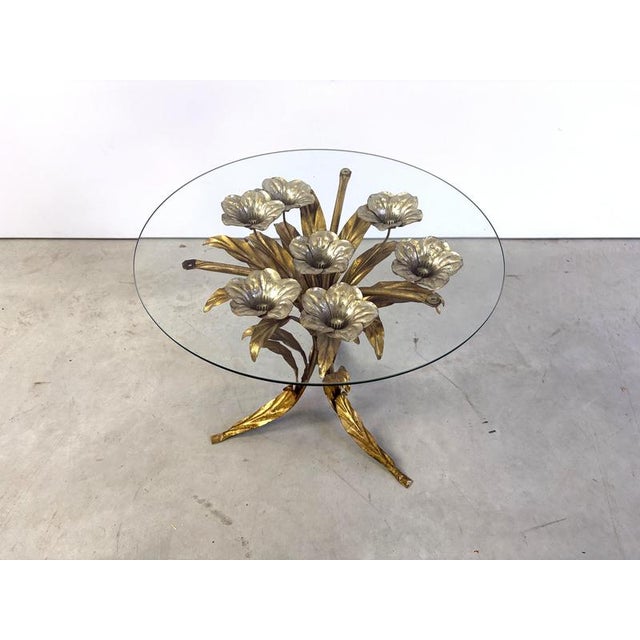 Charming metal flower coffee table or side table with a clear glass top. Made in Italy, attributed to Hans Kögl. Beautiful...