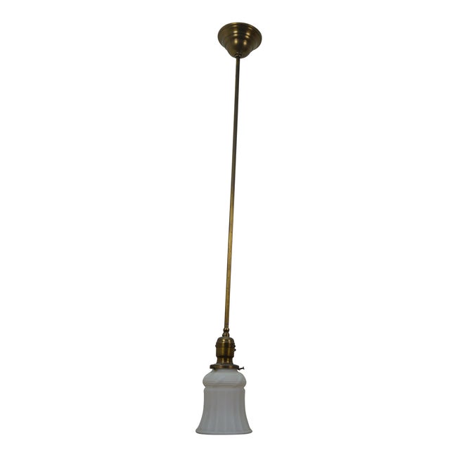 Early 20th century brass stick pendant ceiling light with round bel shaped medallion and fluted matte milk glass shade /...
