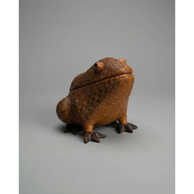A true statement piece for the collector at heart, this vintage woven frog brings playful charm and artisan craftsmanship...
