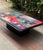 Colorful and unique lacquered pedestal coffee table signed by artist Ron Kemper, likely 1980s or early 90s. Featuring an...