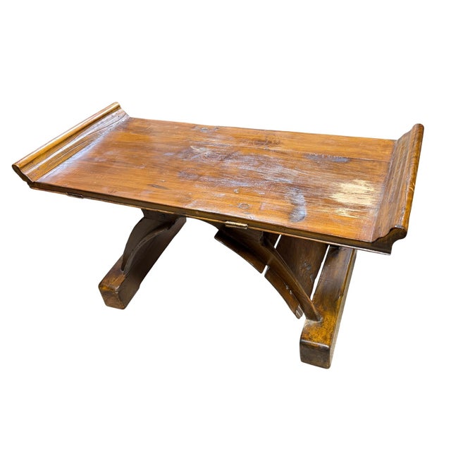 This is a rustic primitive wooden table with a flanged top, often associated with antique furniture styles like alpine...