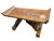 This is a rustic primitive wooden table with a flanged top, often associated with antique furniture styles like alpine...