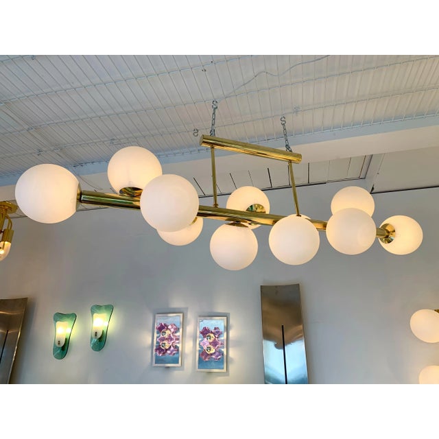 Nice size of chandelier ceiling pendant light full brass and murano opaline glass ball. Good form to cover a dining table....