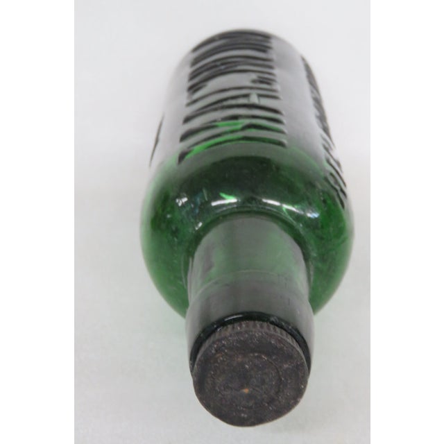 This wonderful vintage bottle is made of glass. This bottle made in a gorgeous emerald green color, this bottle is from...