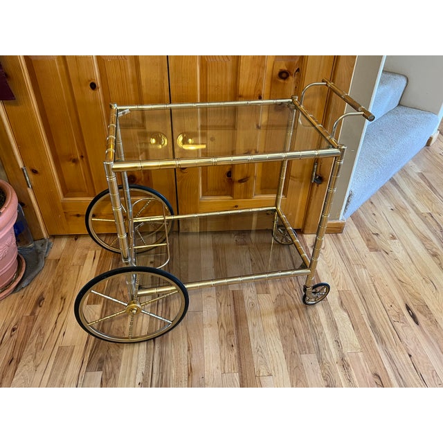 Mid Century Modern 2-tier bar cart with three bottle holder, shaded bottom glass and clear top glass. Two large 6 spoked...