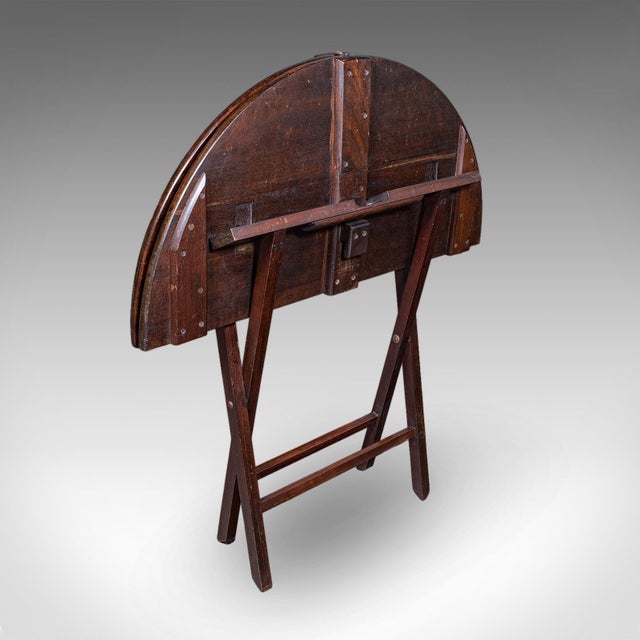 This is an antique kitchen garden table. An English, mahogany folding coaching or occasional table, dating to the...