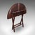 This is an antique kitchen garden table. An English, mahogany folding coaching or occasional table, dating to the...