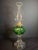 This exceptional Victorian-era composite kerosene stand lamp features a vibrant emerald green pressed glass font with...