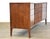A mid century modern walnut nine drawer dresser with wavey drawers with a curved front made by Unagusta Strata Line....