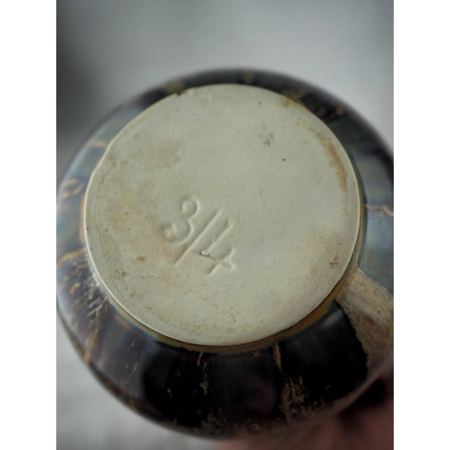 Little round pitcher, medium neck, glazed stoneware with impressive blue and pink shades. The simplicity of these pitchers...