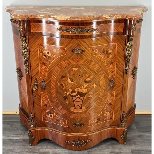 A stunning Vintage French cabinet featuring a richly coloured marble top, intricate floral marquetry, and ornate brass...