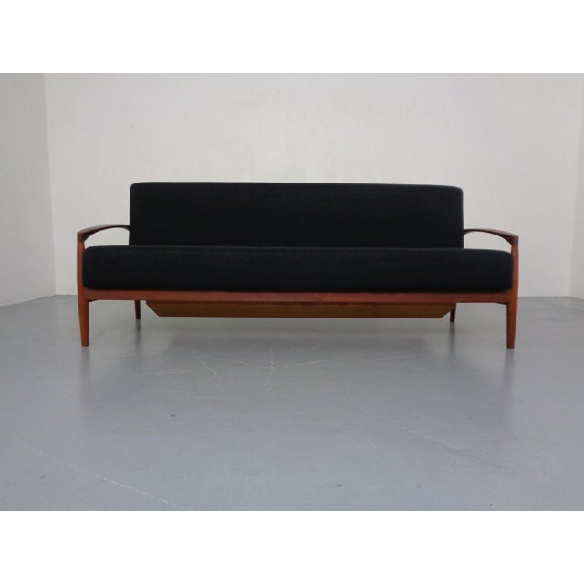 Sofa that converts into a daybed, featuring the original storage compartment by Carl Straub from the 1950s. When unfolded,...