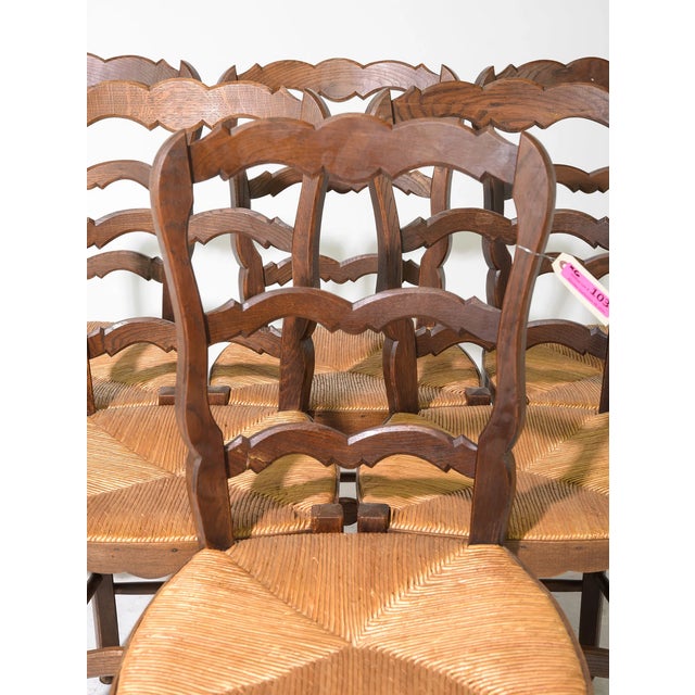 This delightful set of six oak dining chairs features classic rush seats that remain in good vintage condition. The...