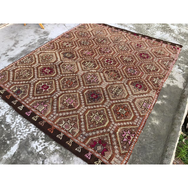 This is a vintage Turkish Anatolian kilim rug from the 1960s. The piece was hand-woven.