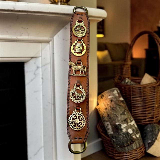 A handsome vintage leather horse brass martingale featuring five richly patinated brass ornaments celebrating classic...