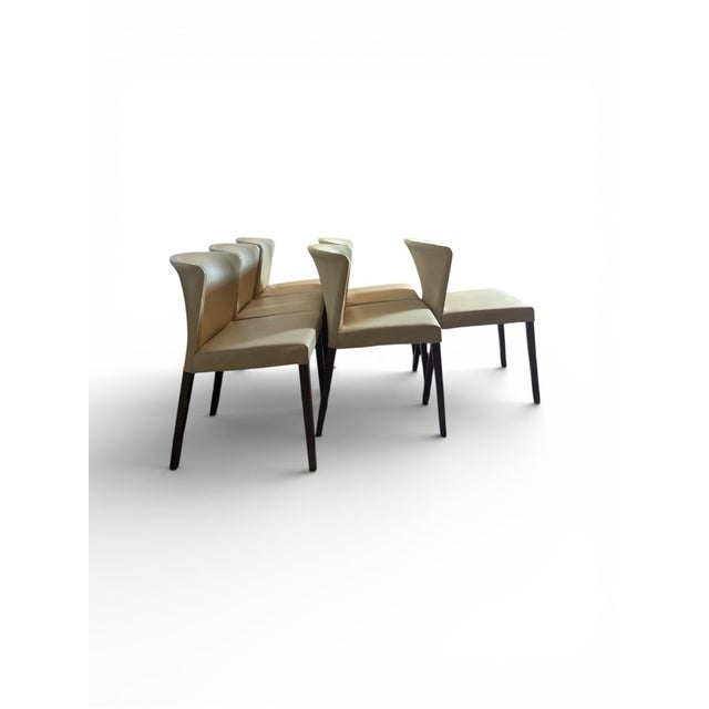 Sleek Italian design cradles comfort with a gracefully curved back that hugs the body. Upholstered in rich, pebble-...