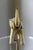 Vintage elephant sculpture featuring a raised trunk and a beautifully aged ivory/cream, grey and dark toned surface with...