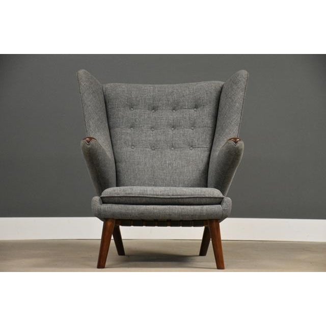An original iconic teak Papa Bear chair and ottoman designed by Hans J. Wegner for AP Stolen recently reupholstered in...