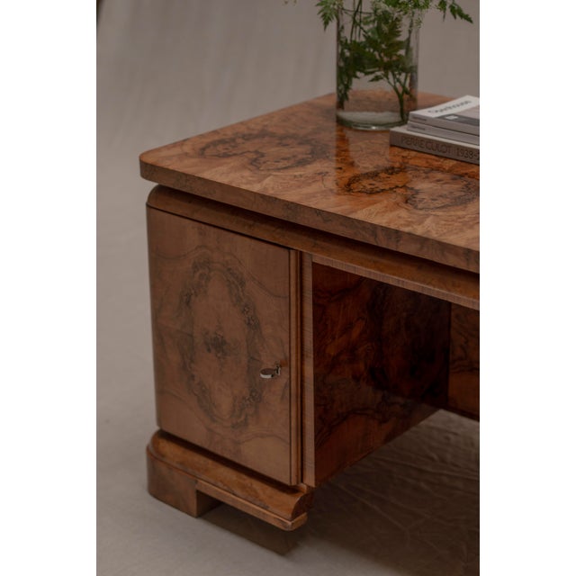 Elegant Art Deco desk from the 1940s, beautifully crafted in richly figured burlwood veneer with warm earthy tones and...