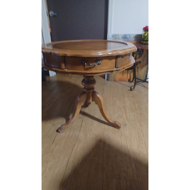 Beautiful pedestal drum table with gold embossed leather inlay and scalloped edges. In great condition with normal age...