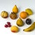 A striking 10-piece collection of vintage Italian hand-carved stone fruit with hand-painted finishes and beautifully...