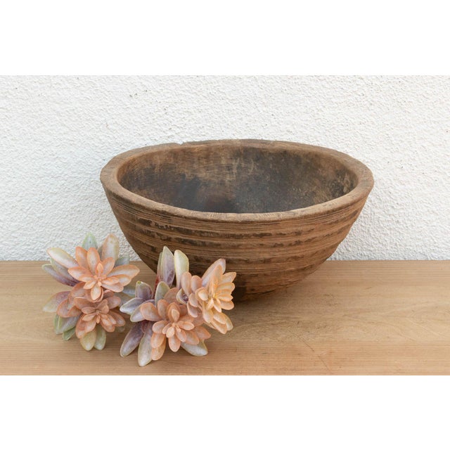 There is something deeply grounding about holding a vessel that was hewn by hand from a single block of wood. This antique...