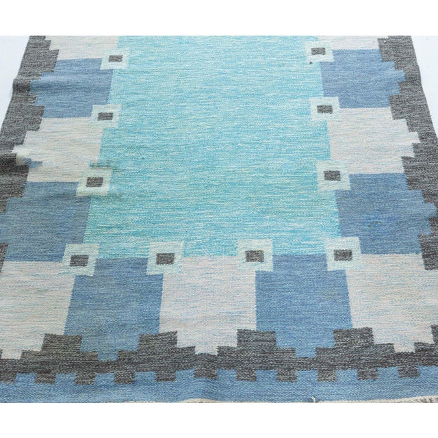 Vintage Swedish blue flat woven rug by Ingegerd Silow Size: 5'2" × 8'0" (157 × 243 cm) Crafted by the esteemed Swedish...