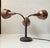 A very rare fully adjustable 3-shaded table or desk lamp. It has patinated solid copper shades and flexible brass...
