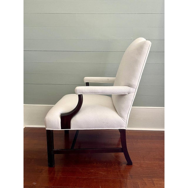 A traditional design updated with inviting upholstery, this comfortable arm chair is newly reupholstered in soft white...