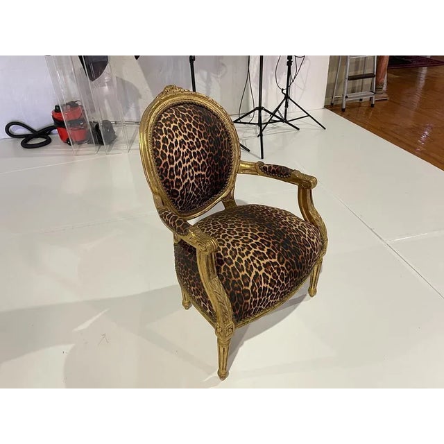 20th century German armchair in carved and gilded wood, decorated with plant motifs. Seats and back upholstered with...