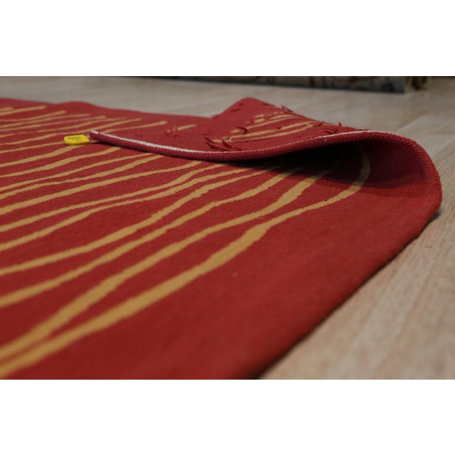 Trendy Sloane Red Flatweave Wool Rug, Country of Origin: China. This striking flatweave piece offers a bold, contemporary...