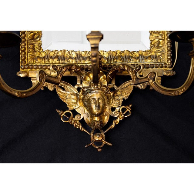 Pair of Napoleon III "Ventoline" mirrors in gilded and chiselled bronze belonging to the second half of the 19th century....