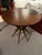 Heritage Home accent table with a round wood top and brass metal base that adds a mid-century inspired look. Light surface...