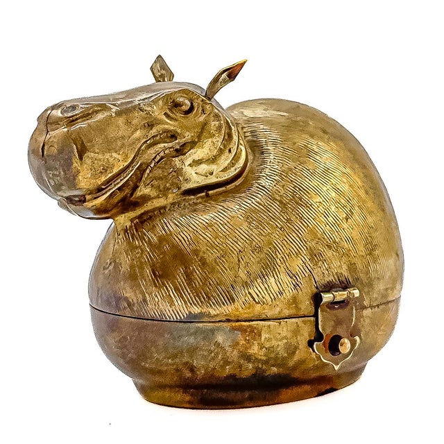 A whimsical mid-century modern heavy brass figural trinket box sculpted in the form of a plump, stylized hippopotamus....