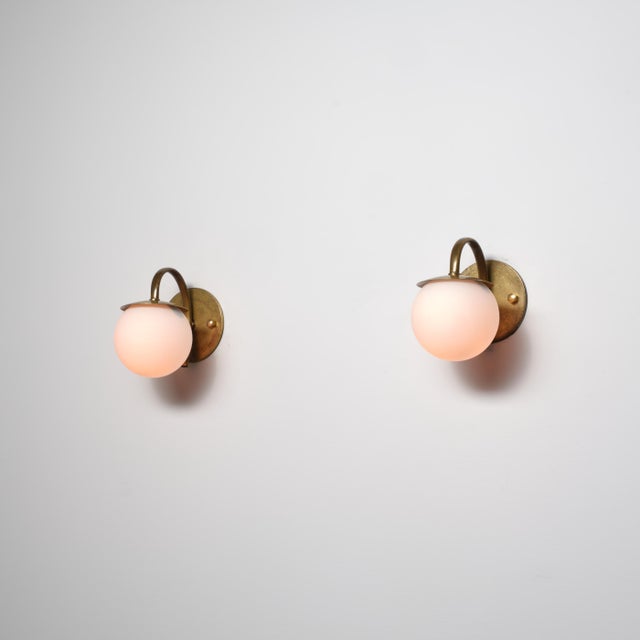 A refined pair of italian wall sconces from the 1950s, characterized by a clean and timeless mid-century design. Each...