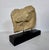 This casted horse head is based on ancient reliefs. Mounted on a simple black pedestal the piece brings and ancient yet...