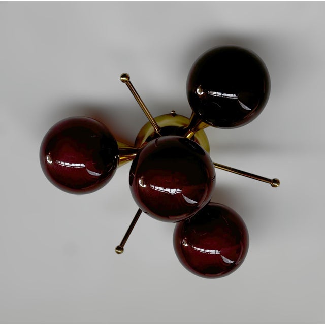 Italian flush mount with 4 frosted amethyst Murano glass globes mounted on solid brass frame in lacquered polished brass...