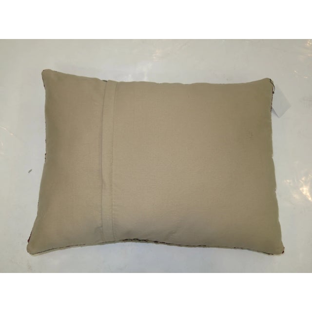 Pillow made from a antique caucasian rug with cotton back. Zipper closure and foam insert provided. 10'' x 16''