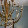 The swirl of long, slender leaves wave as if being stirred by summer breezes on the Menefee Large Gold Chandelier. The...