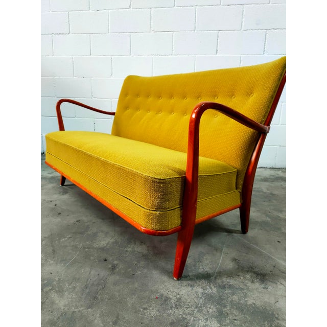 Sofa upholstered in soft mustard-colored fabric, with a beech wood frame, in perfect condition, from the 1970s....