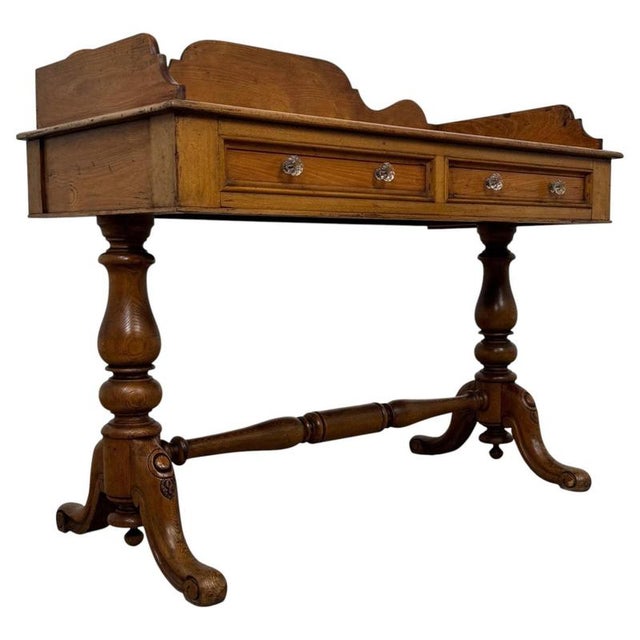A handsome 19th-century English washstand, finely crafted from golden oak and distinguished by its elegant turned legs,...