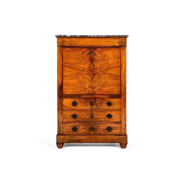 A beautiful walnut Secrétaire à Abattant in the Empire style of the 19th century, The top bears a rounded rectangular...
