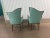 Beautiful pair of carved wood asymmetrical arm chairs. These are upholstered in aqua. The fabric is clean with two small...