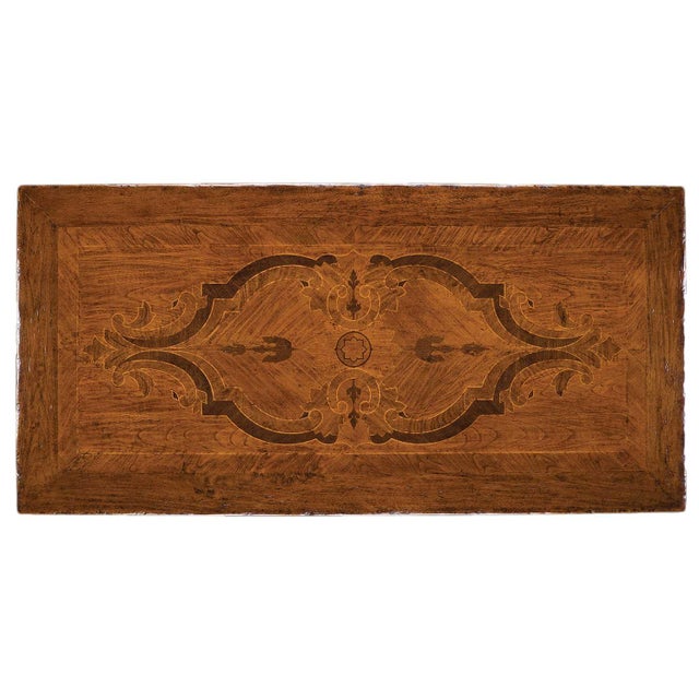 Handcrafted in Italy from solid walnut, this dining table features a rectangular top with decorative inlays in cherry,...