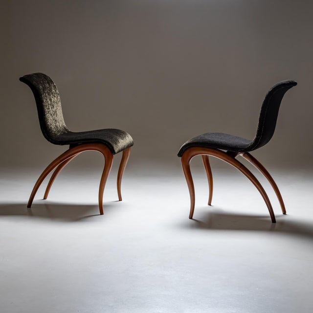A pair of sculptural side chairs designed by Maurizio Marconato & Terry Zappa for Porada in the 2000s. The chairs rest on...