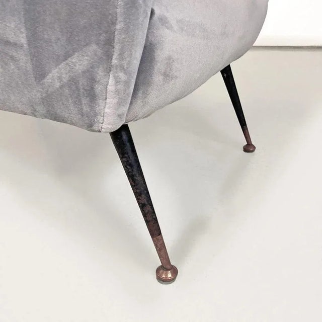 Italian and modern armchair, in light gray velvet with black metal legs, 1960s. Armchair with armrests and structure...