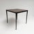 This square vintage dining table by Wim Rietveld combines sleek industrial styling with the warm appeal of wood. Dating...