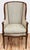 Elegant vintage Neo-Classical style upholstered wingback arm chair with carved walnut wood frame. Fresh upholstery in...